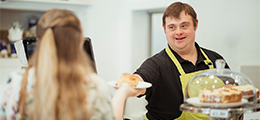 Man with Down syndrome serving at a cafe