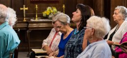 A group of women, sitting in church pews